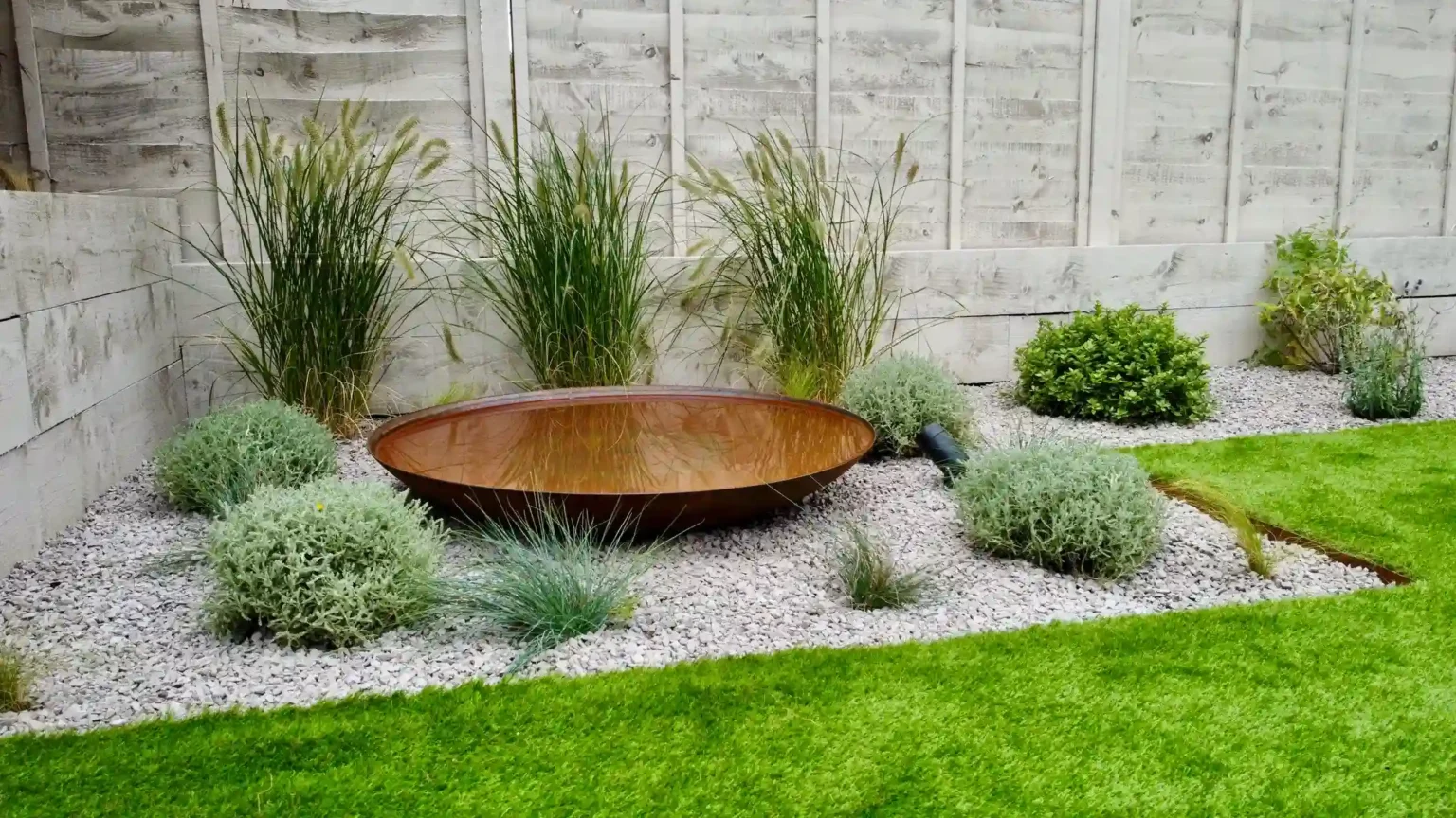 Corten steel water bowl in an EH Landscapes garden in Tiptree